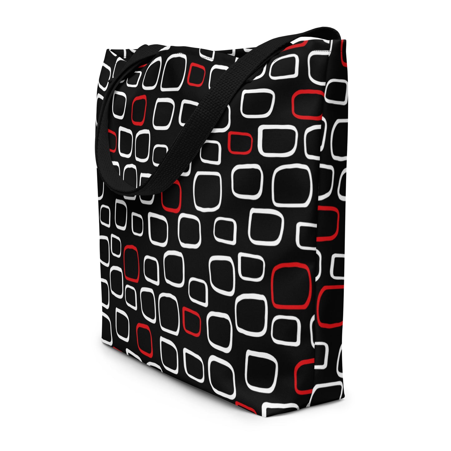 Tote bag with black handles, featuring a black background with red and white outlined geometric squares, creating a modern, playful pattern.
