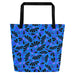 Blue tote bag with black handles, featuring a bold coneflowers pattern of black and purple abstract shapes resembling flowers; a vibrant and modern design.
