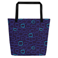 Tote bag with a dark blue background features a pattern of irregularly shaped squares in light blue and purple tones. Black handles provide contrast.