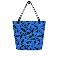 Blue tote bag with black handles, featuring a bold coneflowers pattern of black and purple abstract shapes resembling flowers; a vibrant and modern design.