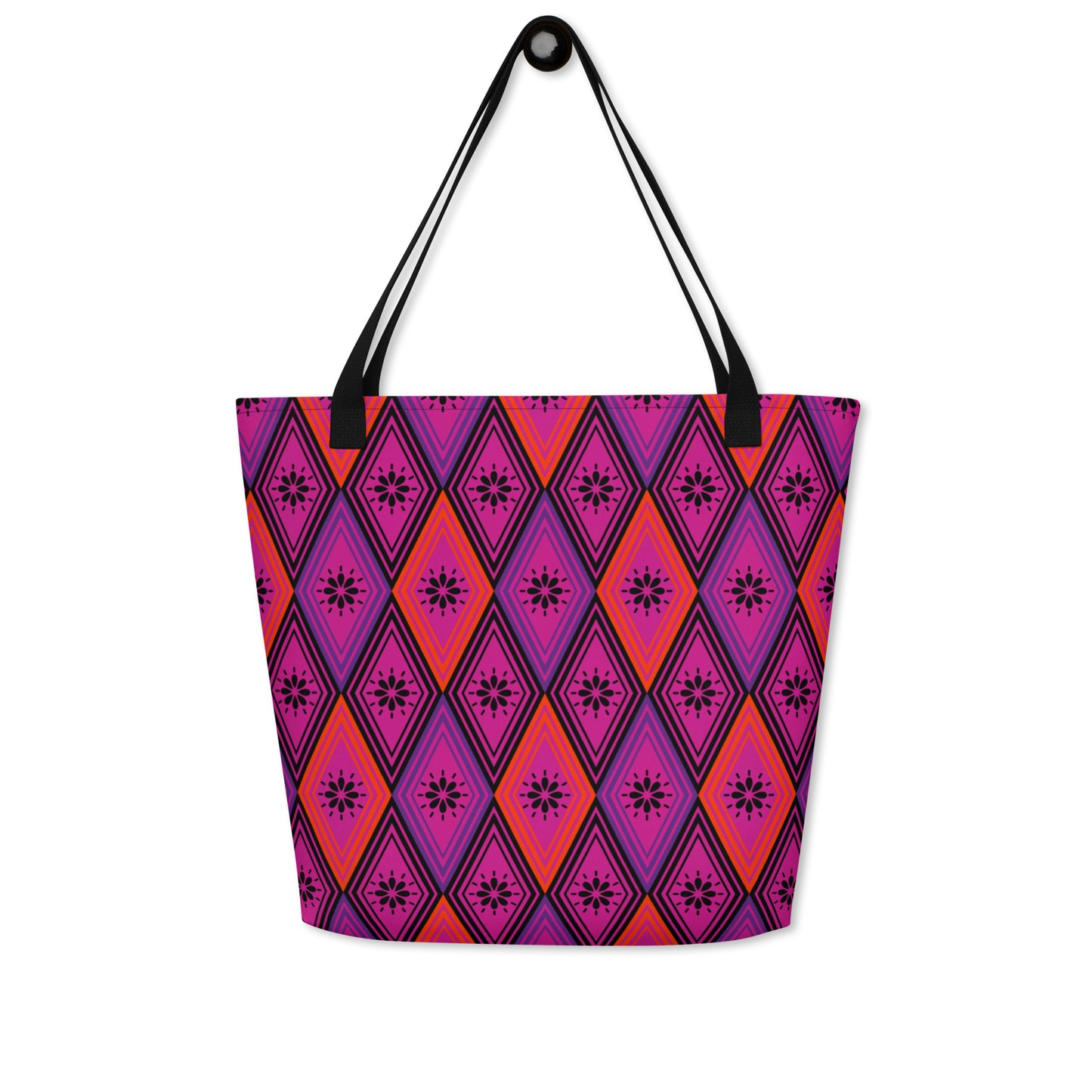 Tote bag with black handles, featuring a vibrant diamond pattern. The design alternates between pink and fuchsia, decorated with black starburst floral motifs.