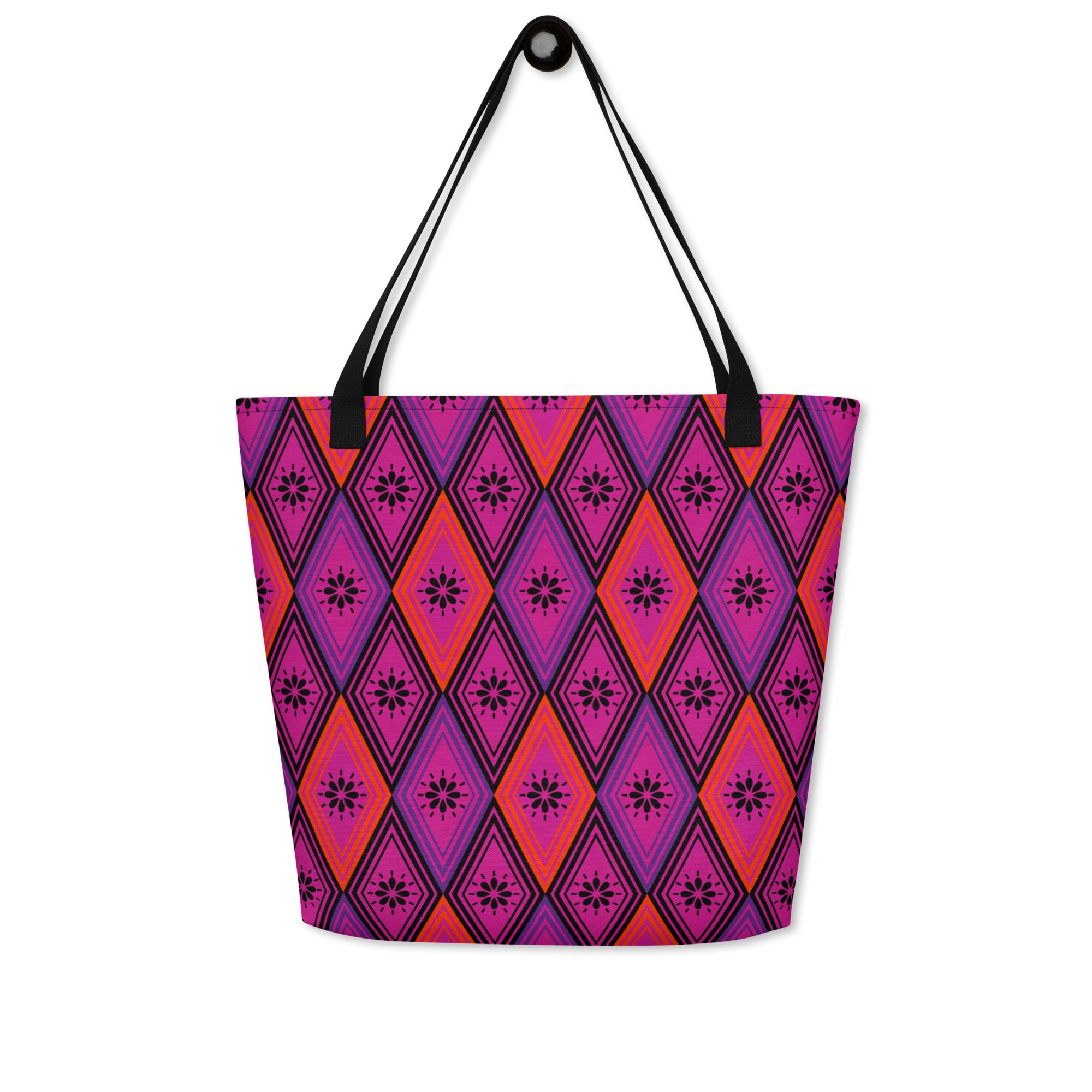 Tote bag with black handles, featuring a vibrant diamond pattern. The design alternates between pink and fuchsia, decorated with black starburst floral motifs.
