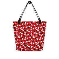 Red tote bag with a bold pattern of alternating black and white petal shapes. Features sturdy black handles, creating a modern and vibrant look.