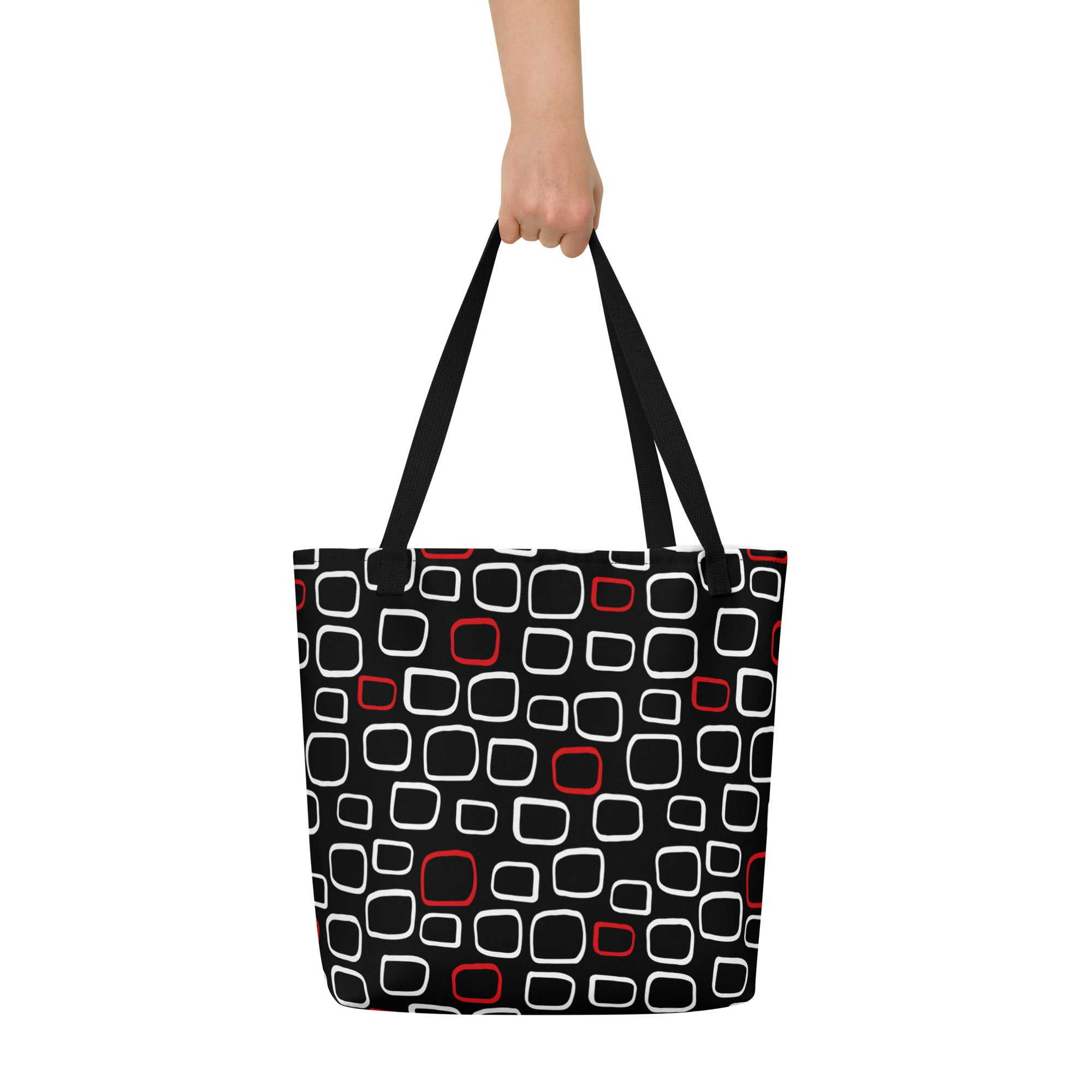 Tote bag with black handles, featuring a black background with red and white outlined geometric squares, creating a modern, playful pattern.
