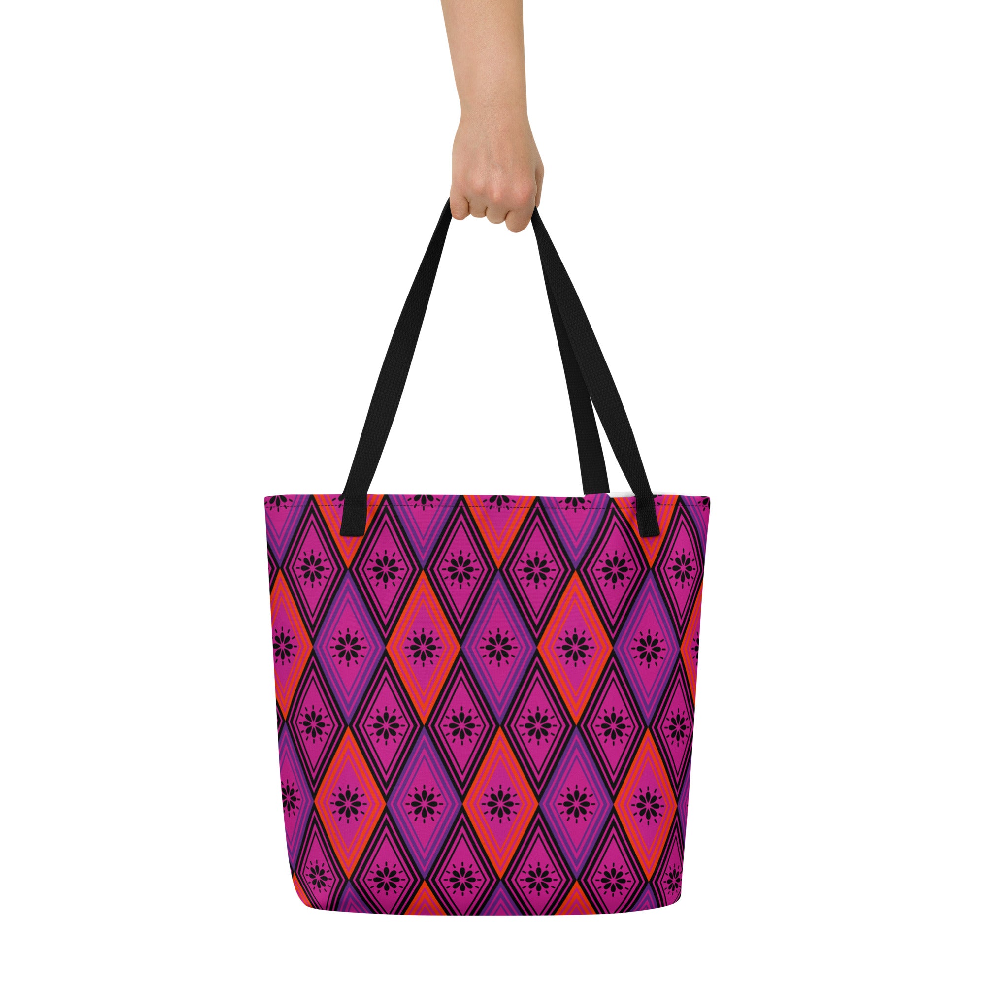 Tote bag with black handles, featuring a vibrant diamond pattern. The design alternates between pink and fuchsia, decorated with black starburst floral motifs.