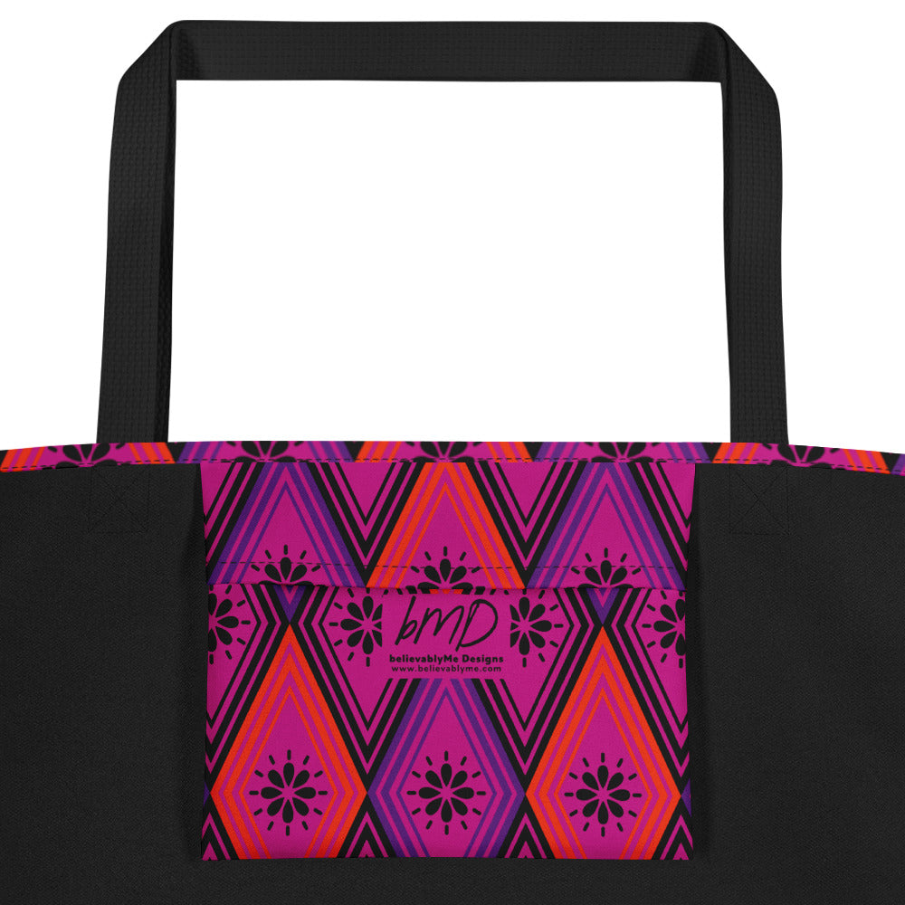 Tote bag with black handles, featuring a vibrant diamond pattern. The design alternates between pink and fuchsia, decorated with black starburst floral motifs.