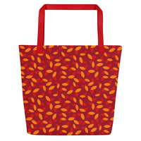 Red tote bag with orange and yellow petal pattern, creating a vibrant, autumnal feel. Red handles complement the warm colors of the design.
