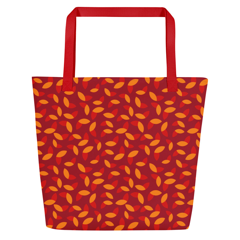 Red tote bag with orange and yellow petal pattern, creating a vibrant, autumnal feel. Red handles complement the warm colors of the design.