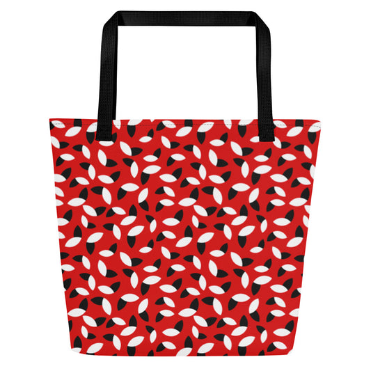 Red tote bag with a bold pattern of alternating black and white petal shapes. Features sturdy black handles, creating a modern and vibrant look.