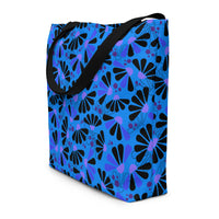 Blue tote bag with black handles, featuring a bold coneflowers pattern of black and purple abstract shapes resembling flowers; a vibrant and modern design.